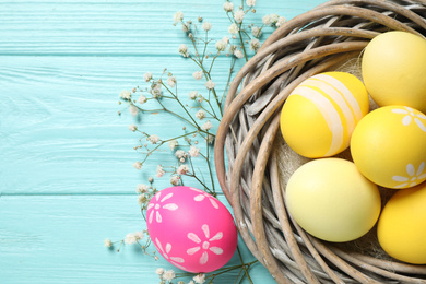 Flat lay composition with Easter eggs on light blue wooden background