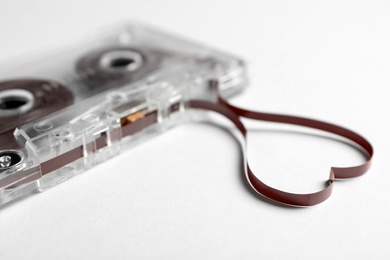 Photo of Music cassette and heart made with tape on white background, closeup. Listening love song