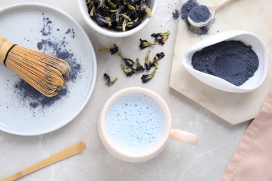 Image of Flat lay composition with blue matcha latte on light grey marble table