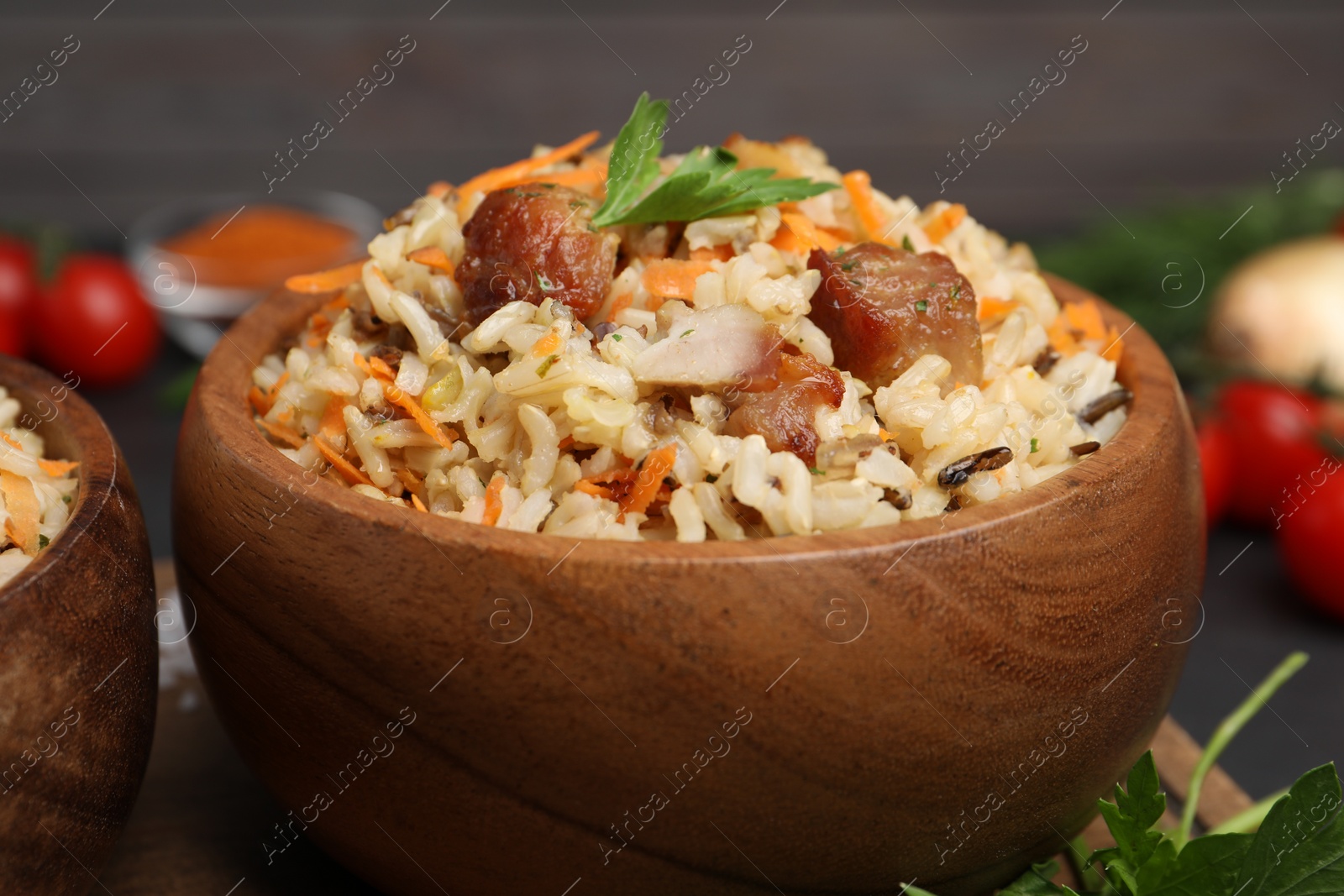 Photo of Delicious pilaf with meat and carrot in bowl on table, closeup