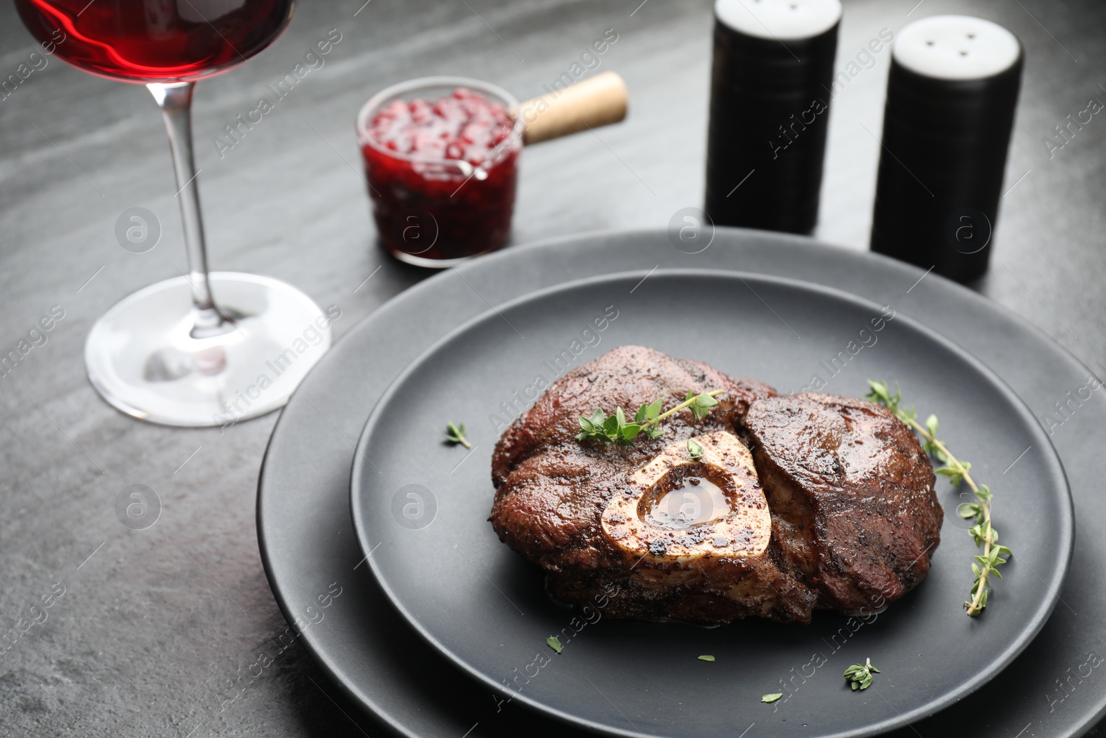 Photo of Tasty grilled beef meat served on black table, closeup