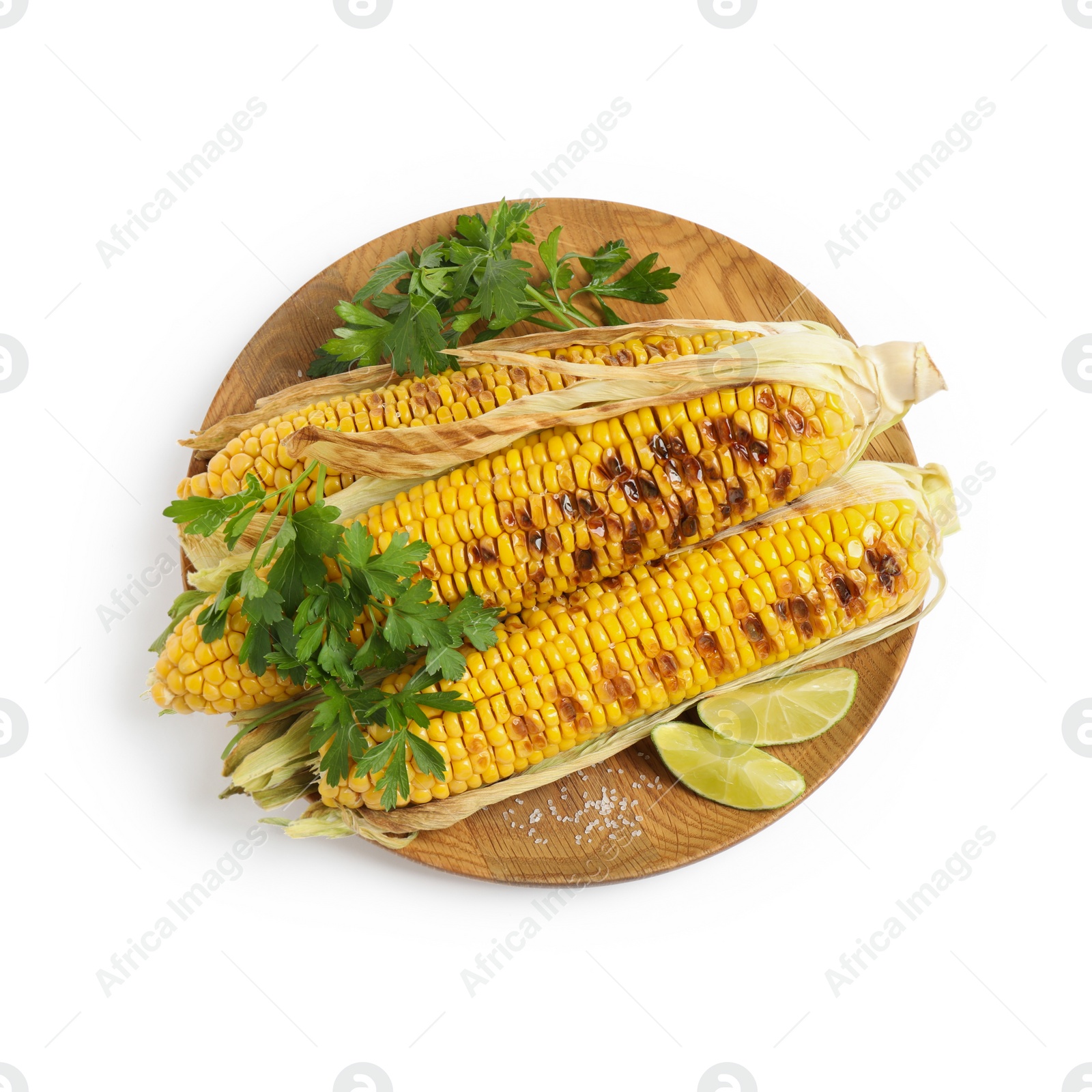 Photo of Delicious grilled corn cobs with parsley and lime on white background, top view