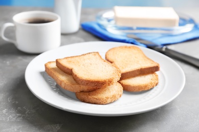 Photo of Plate with toasted bread on table