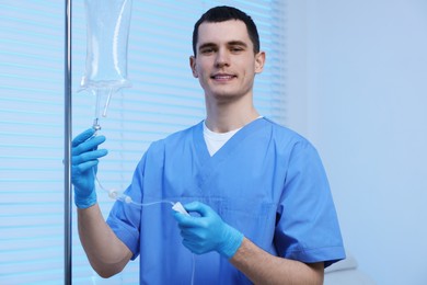 Photo of Nurse setting up IV drip in hospital