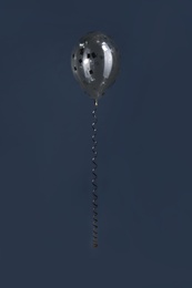 Photo of Bright balloon with sparkles on dark background