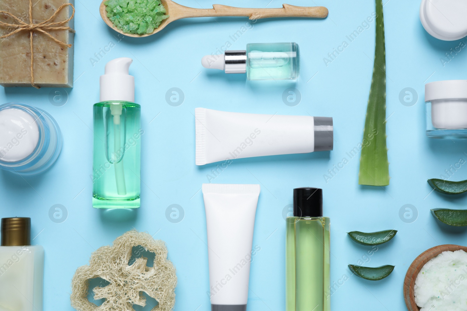 Photo of Flat lay composition with aloe vera and cosmetic products on light blue background