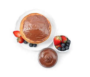 Photo of Tasty pancakes with chocolate paste and berries isolated on white, top view