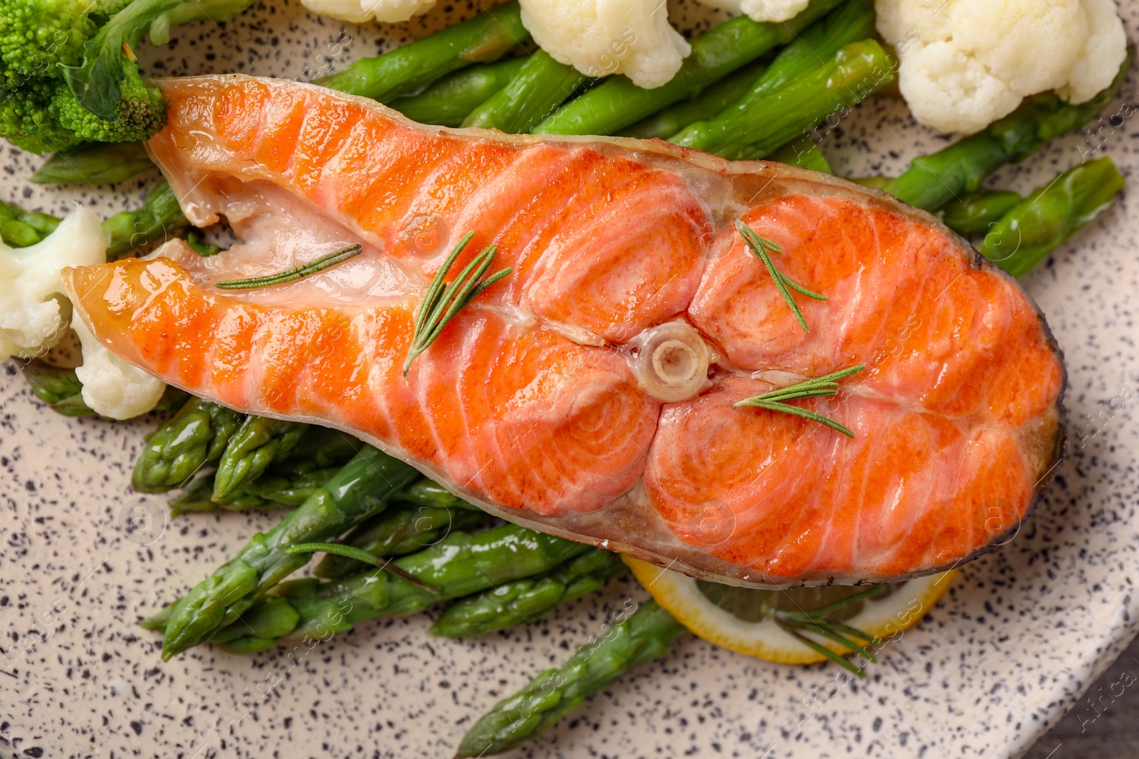 Photo of Healthy meal. Tasty grilled salmon with vegetables on plate, top view