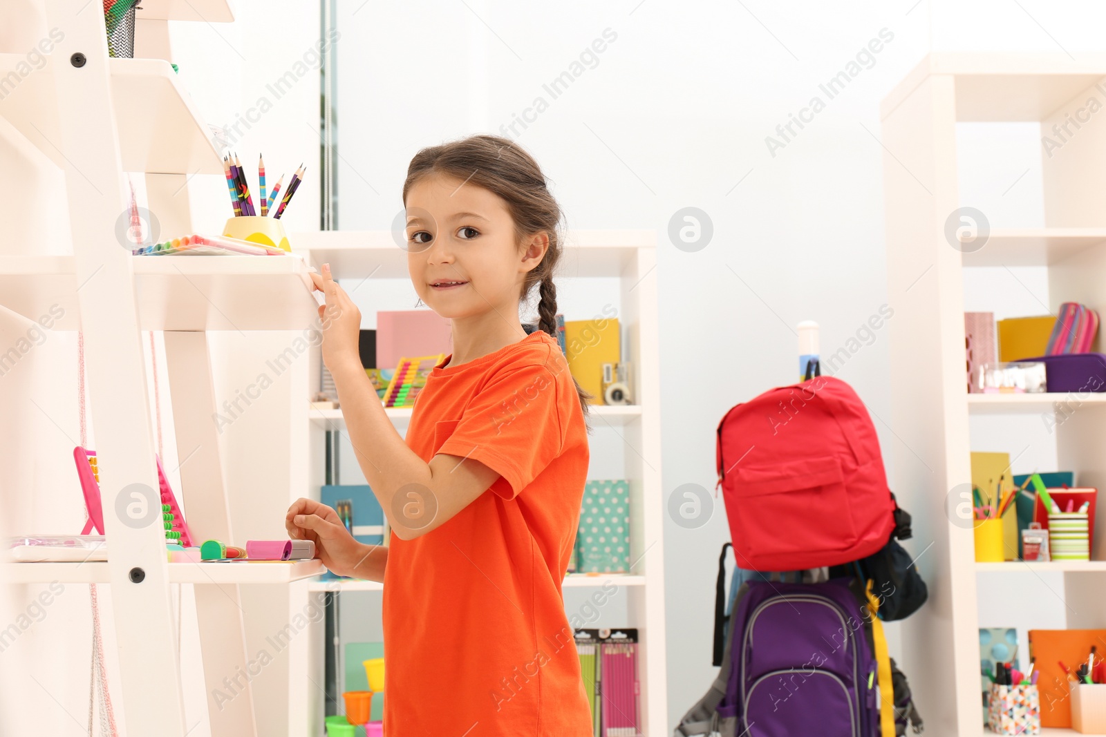 Photo of Cute child choosing school stationery in store