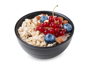 Photo of Ceramic bowl with oatmeal, berries and almonds isolated on white