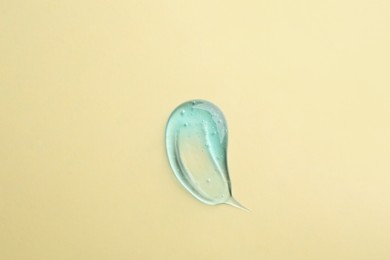 Photo of Smear of ointment on beige background, top view