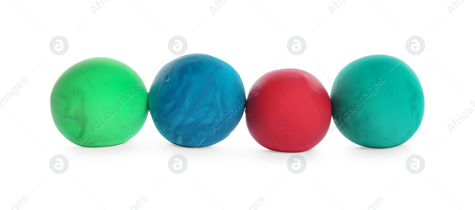 Photo of Row of color play dough balls isolated on white