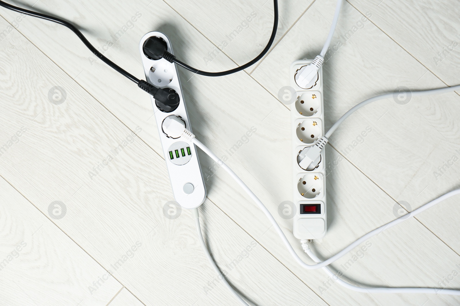 Photo of Extension cords on floor, top view. Electrician's professional equipment