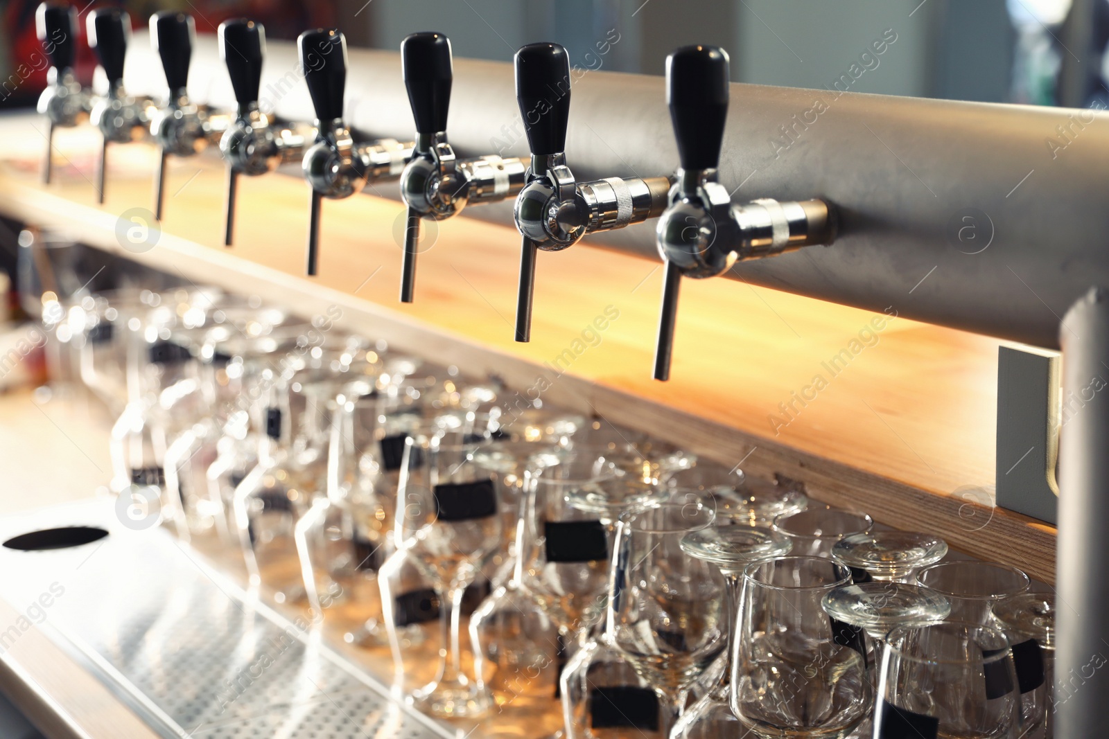 Photo of Row of shiny beer taps in pub