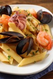 Photo of Delicious pasta with seafood on table, closeup