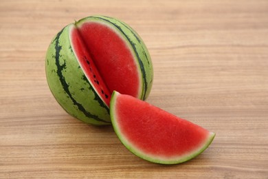 Cut delicious ripe watermelon on wooden table