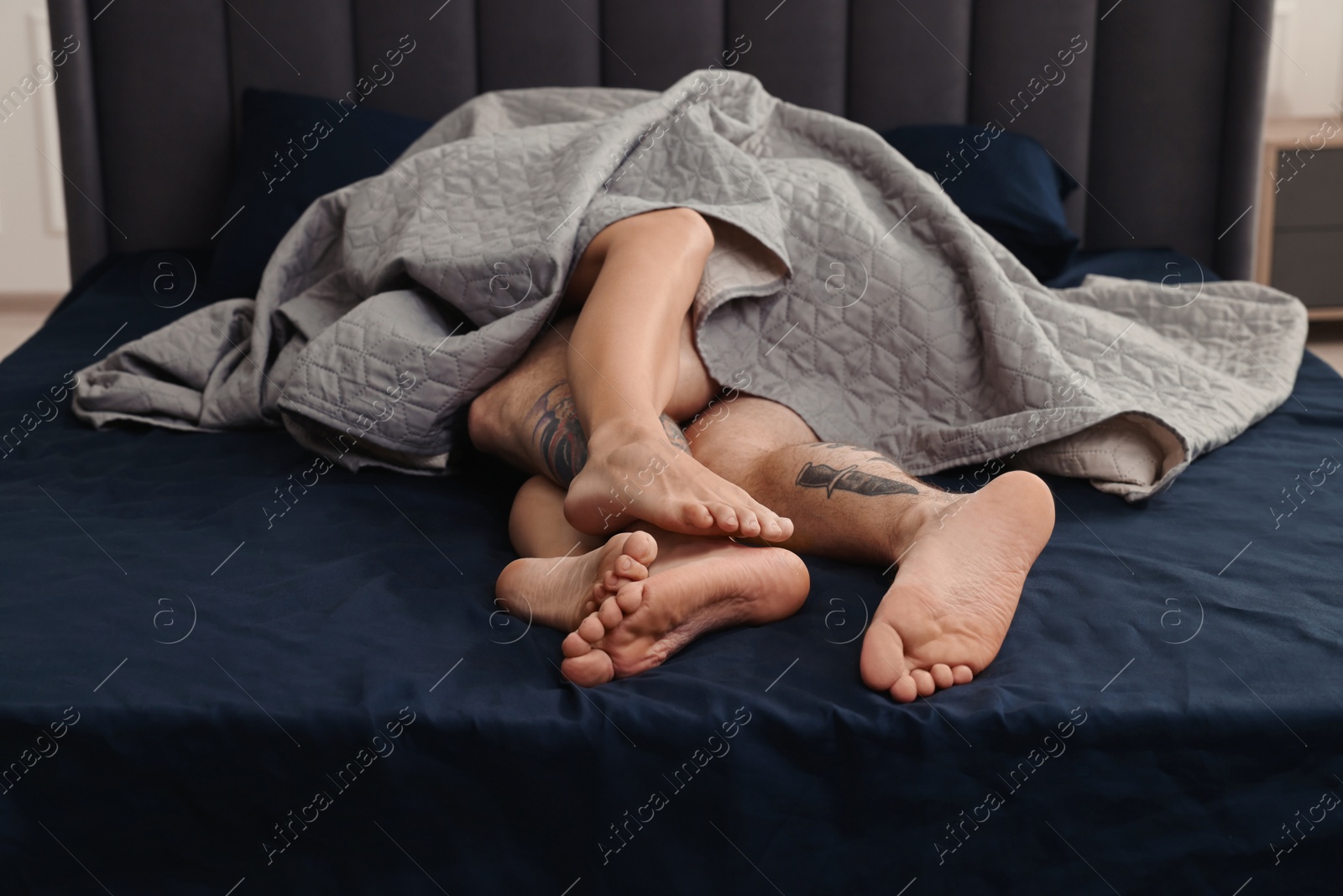 Photo of Passionate couple having sex on bed at home