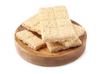 Wooden board with tasty sesame kozinaki bars on white background