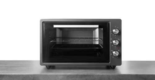 Photo of One electric oven on grey table against white background