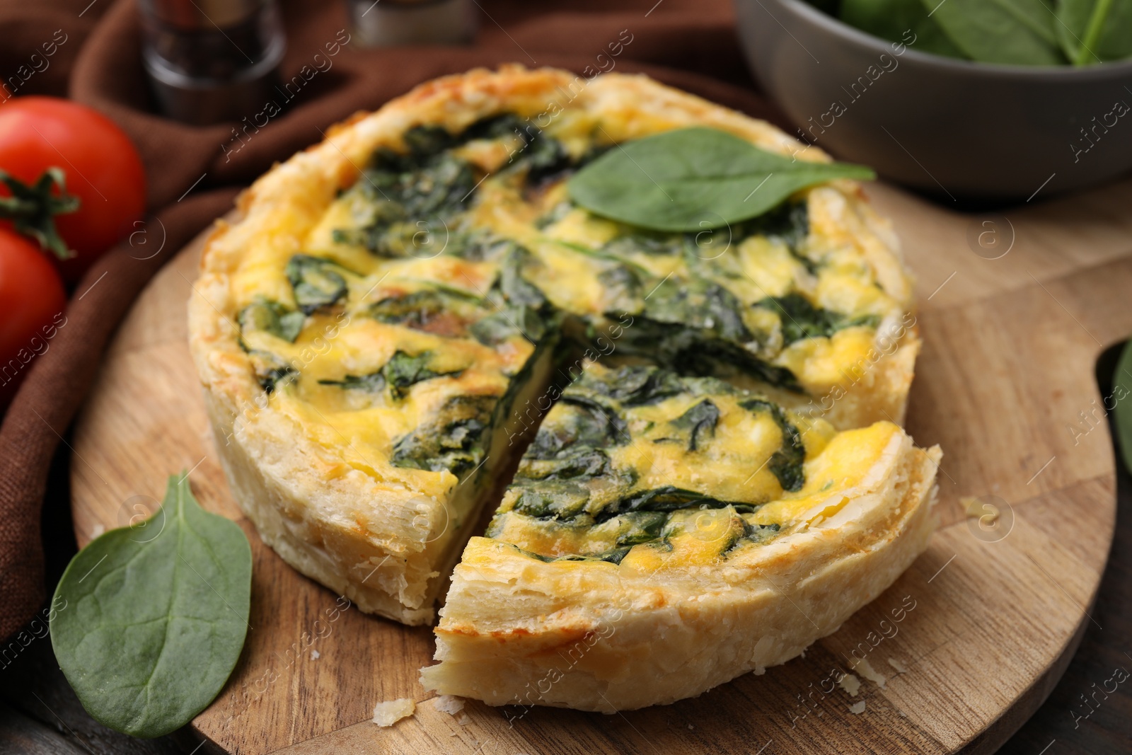 Photo of Delicious pie with spinach on table, closeup