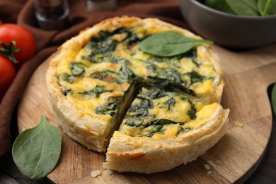 Photo of Delicious pie with spinach on table, closeup