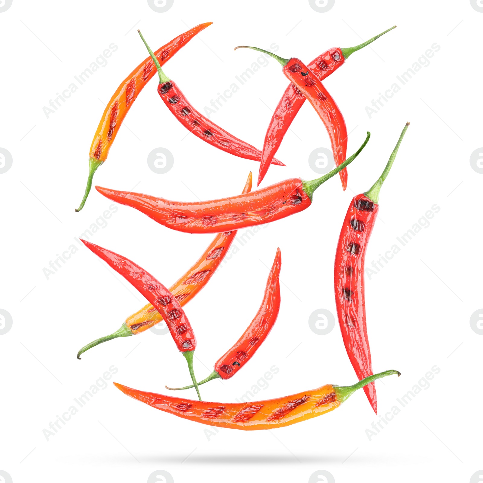 Image of Grilled chili peppers in air on white background