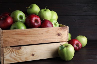 Photo of Fresh ripe red and green apples on black wooden table