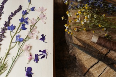 Photo of Composition with beautiful dried flowers and book on wooden table, top view