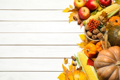 Flat lay composition with ripe pumpkins and autumn leaves on white wooden table, space for text. Happy Thanksgiving day