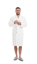 Photo of Handsome man in bathrobe with cup of coffee on white background