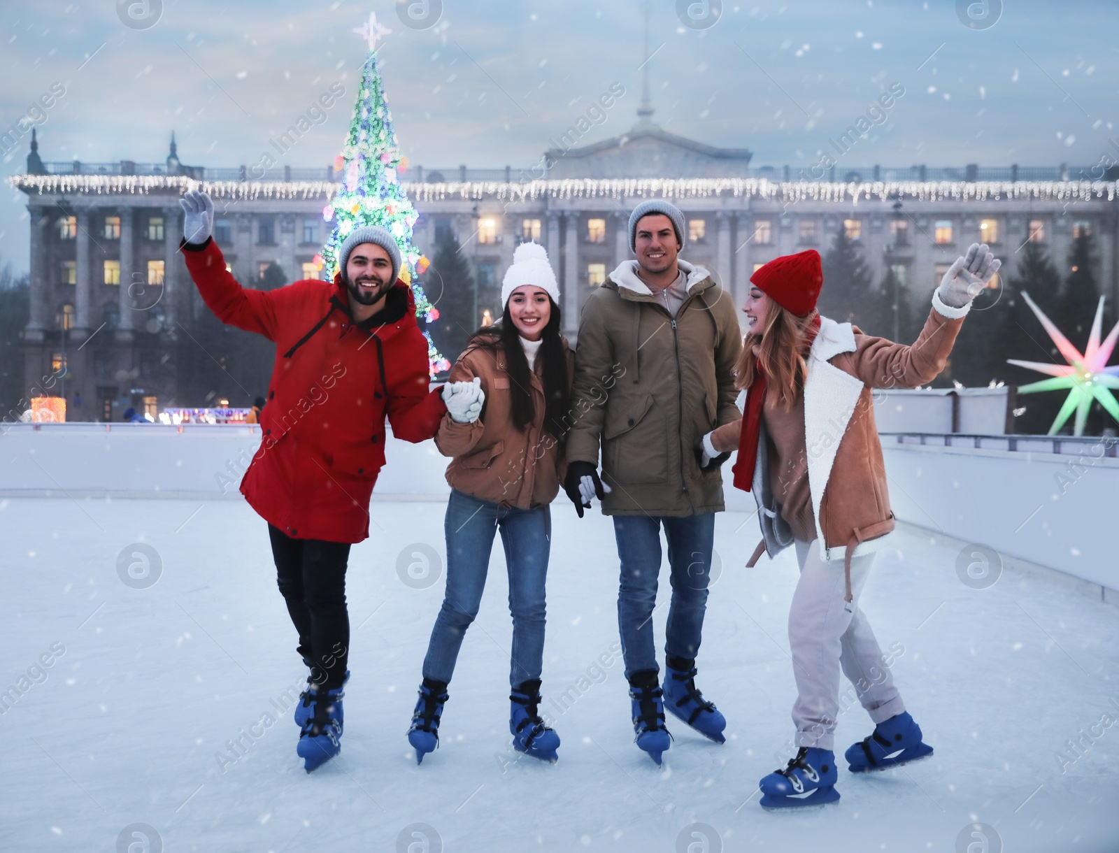 Image of Group of friends skating at outdoor ice rink