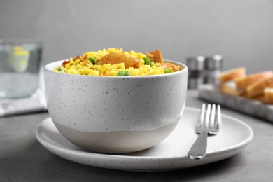 Delicious pilaf with chicken meat on light grey table