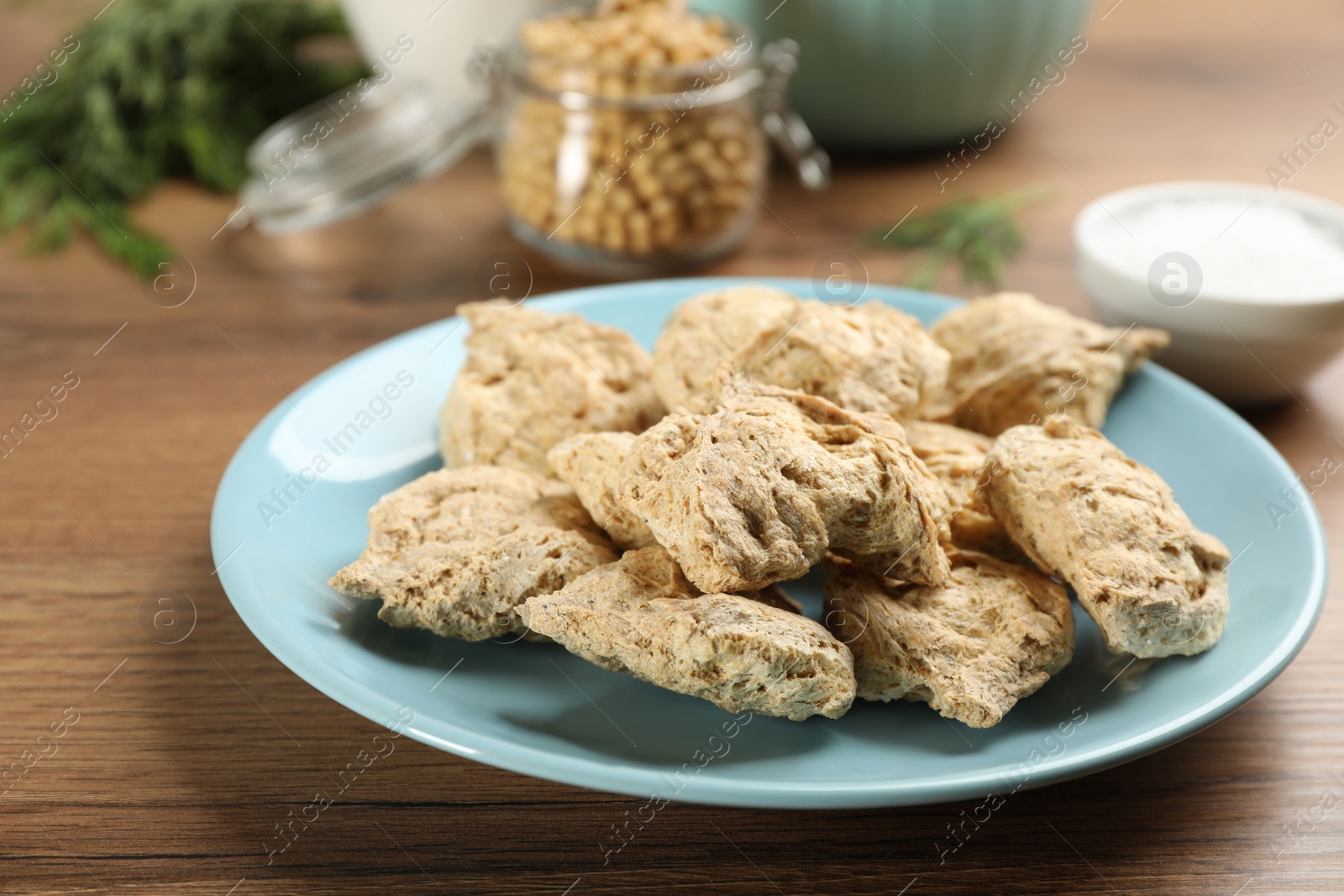 Photo of Dried soy meat on wooden table, closeup