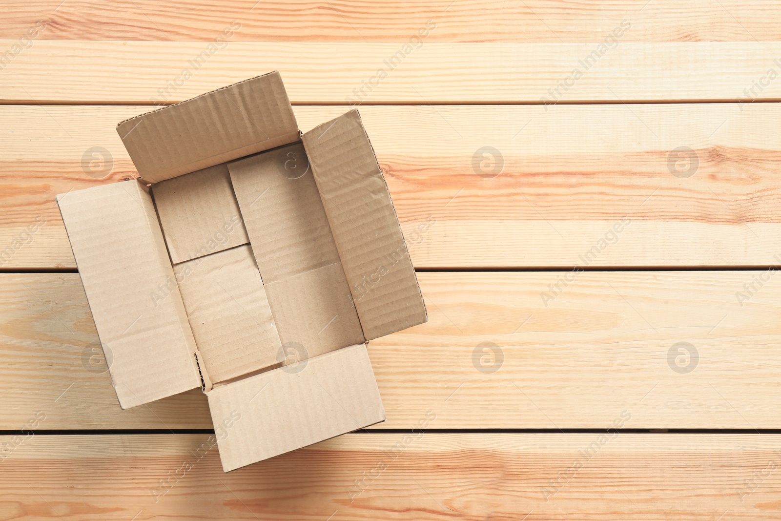 Photo of Cardboard box on wooden background