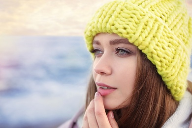 Photo of Portrait of beautiful young woman near sea, closeup. Space for text