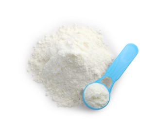 Photo of Powdered infant formula and scoop on white background, top view. Baby milk