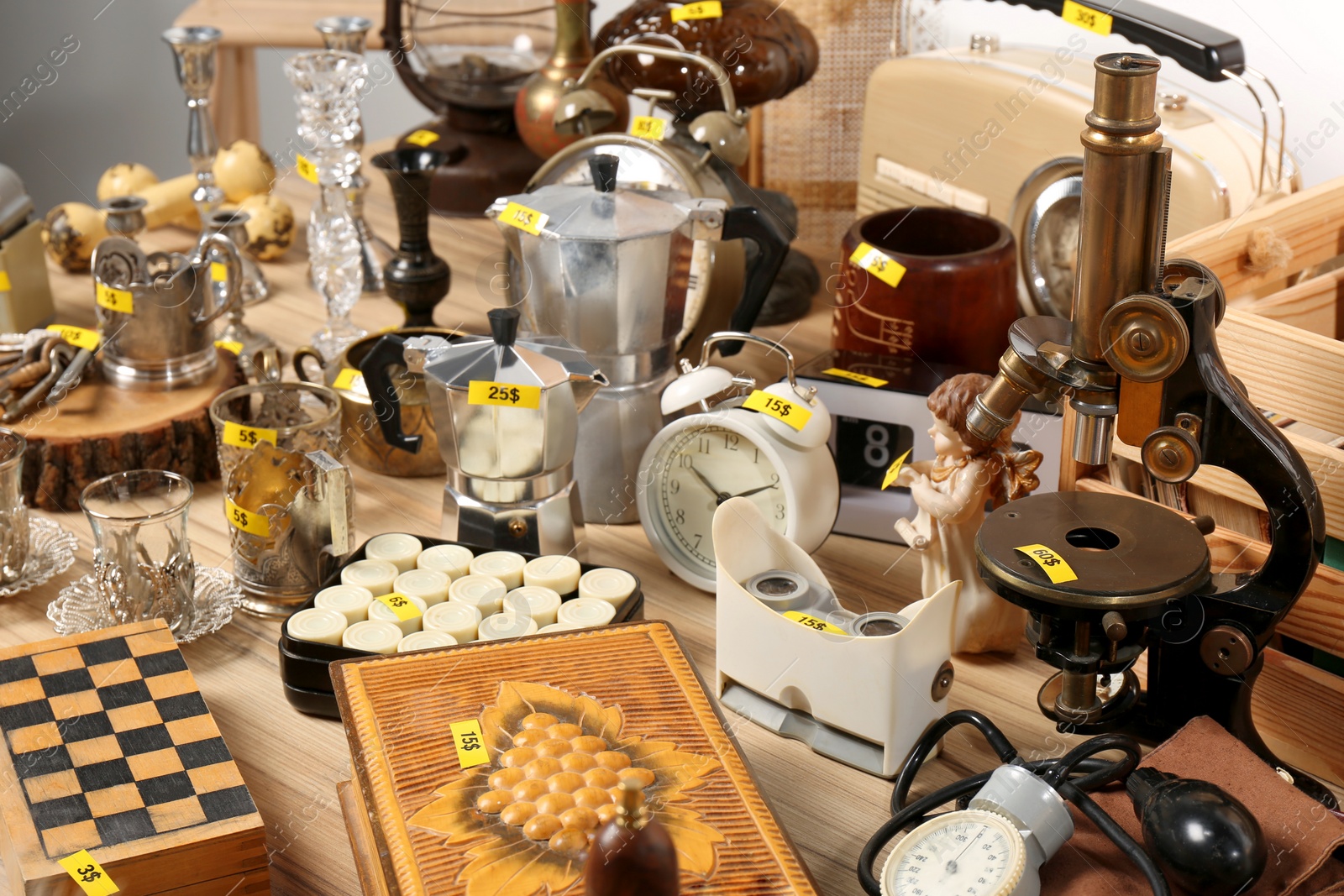 Photo of Many different items on wooden table. Garage sale