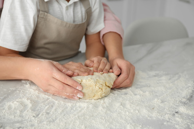 Mother and son cooking together at table, closeup