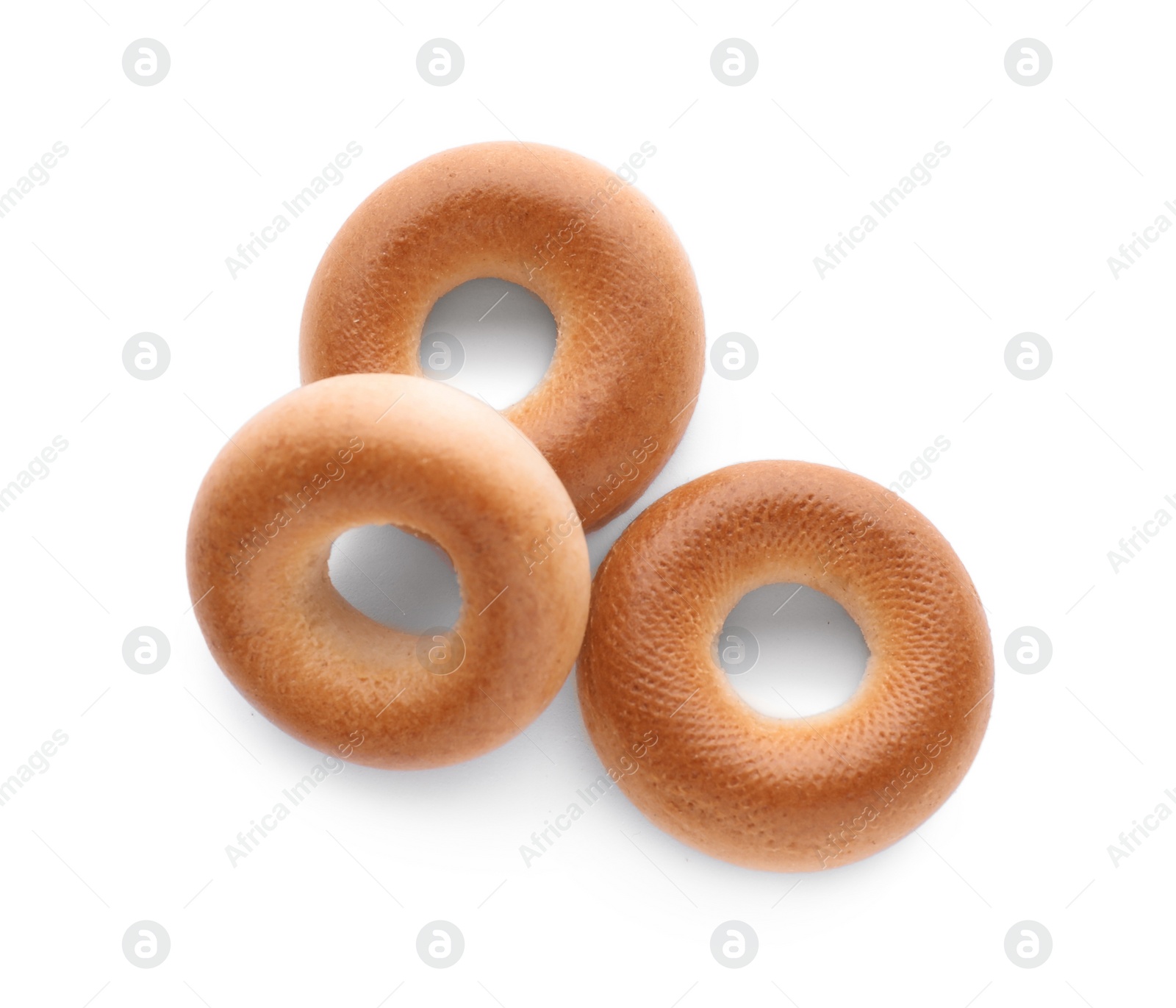 Photo of Tasty dry bagels (sushki) isolated on white, top view