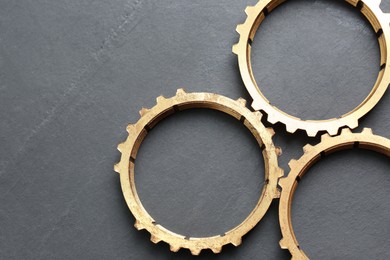 Photo of Stainless steel gears on grey background, flat lay. Space for text