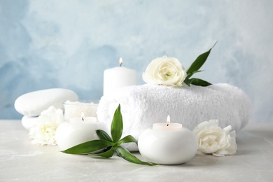 Photo of Beautiful spa composition with candles and flowers on table