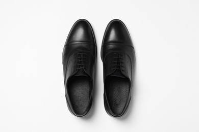 Photo of Pair of leather men shoes on white background, top view