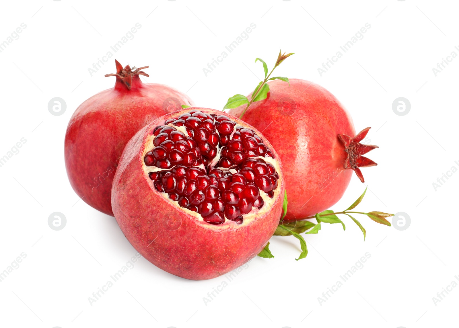 Photo of Fresh ripe pomegranates and green leaves isolated on white