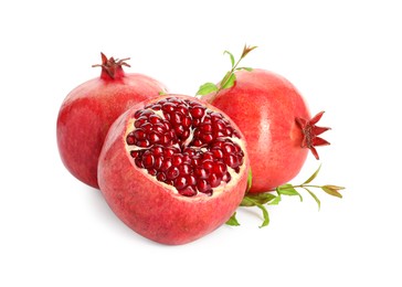 Fresh ripe pomegranates and green leaves isolated on white