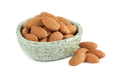 Photo of Bowl and organic almond nuts on white background. Healthy snack