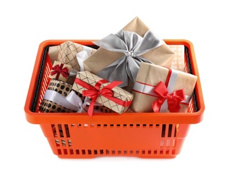 Photo of Orange shopping basket with different gifts on white background