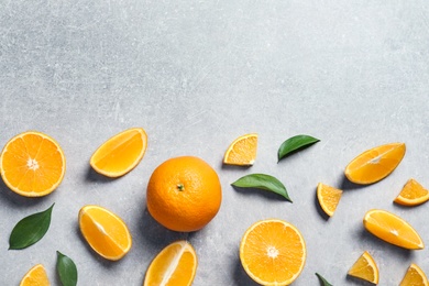 Photo of Flat lay composition with fresh oranges on grey background. Space for text