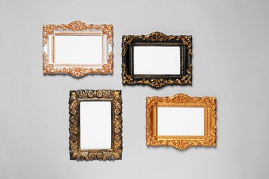 Photo of Empty vintage frames hanging on light gray wall