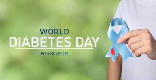 Image of World Diabetes Day. Woman holding light blue ribbon with paper blood drop against blurred green background, closeup. Banner design