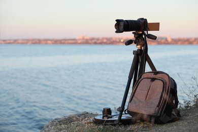 Photo of Professional photography equipment on rocky river coast